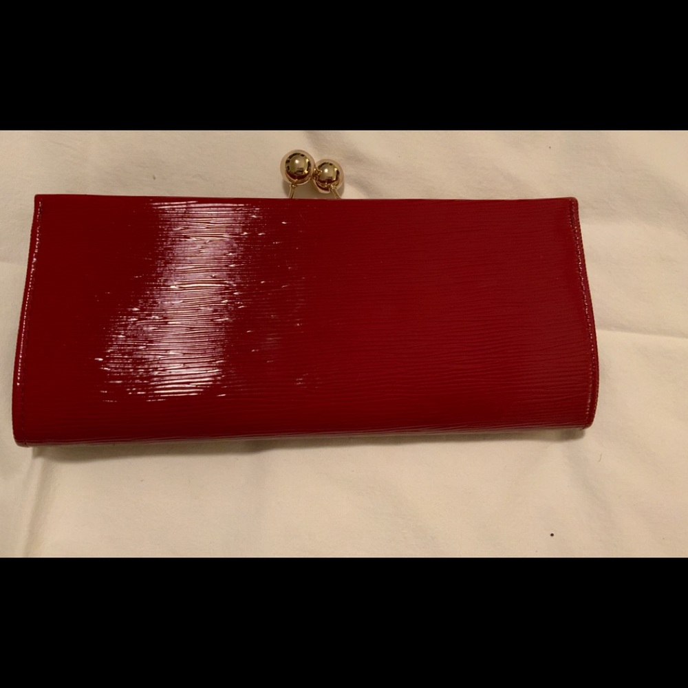 MMS DESIGN STUDIO deep red evening clutch with gold clasp.Surface has li…